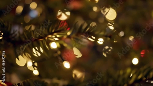 Macro Shot of Festive Christmas Pine Tree Needles with Magical Golden Bokeh Lights and Cozy Winter Atmosphere