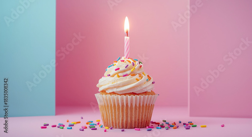  Colorful birthday cupcake with single candle and sprinkles on pastel pink and blue background, festive dessert celebration concept