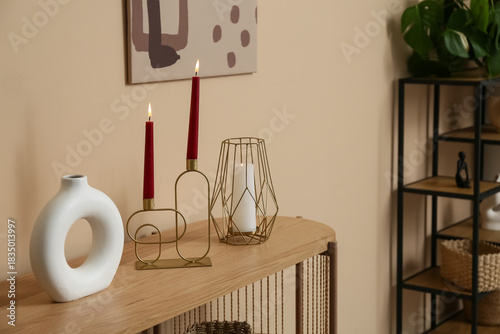 Stylish candles on commode ...