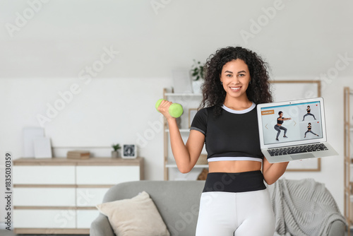 Smiling young woman exercis...