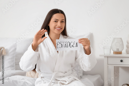 Young woman holding paper w...