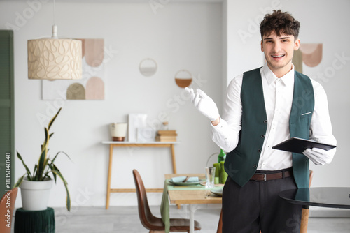 Male waiter with menu in re...