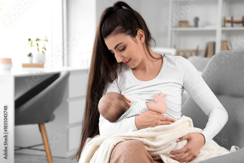 Young woman breastfeeding h...