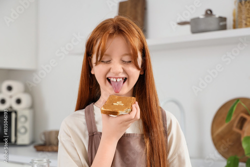 Teenage redhead girl eating...