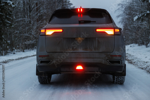 Centered SUV Rear Lights On Snow, Symmetrical Brake Pattern Reflecting On Wet Surface, Dirty Hatchback