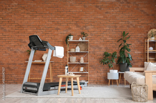 Treadmill near brick wall i...
