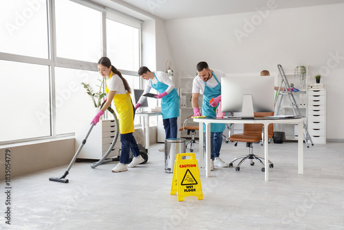 Team of young janitors clea...