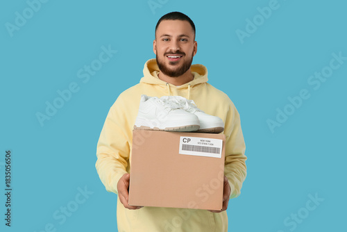 Young man with parcel box a...