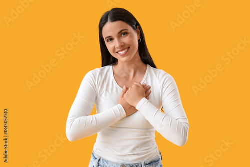 Thankful young woman on yel...