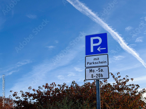 German blue parking sign with parking hours outdoors 