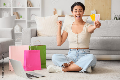 Excited young woman holding...