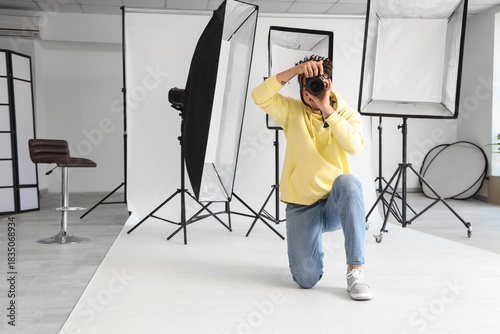 Photographer kneeling with ...