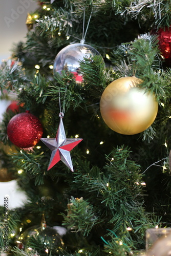 Bild auf Leinwand Christmas tree decorated with ornaments and festive lights for the holidays
