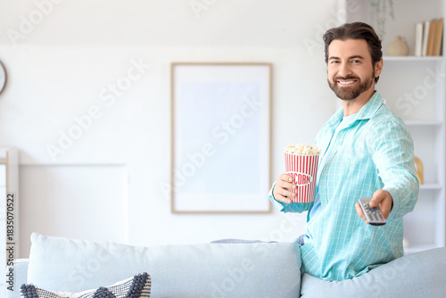 Young man with popcorn and ...