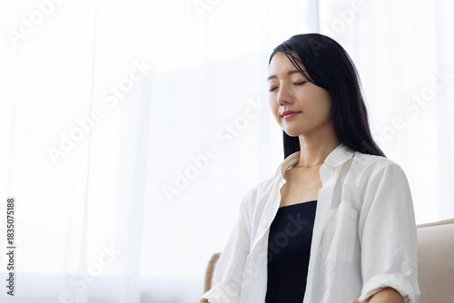 Free Download Japanese Woman Meditating on Sofa at Home - GFXLoad