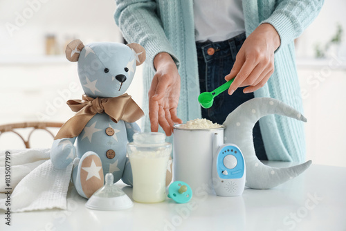 Woman preparing baby milk f...