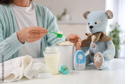 Woman preparing baby milk f...