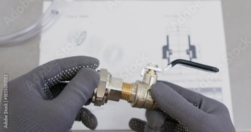 Plumber threads coupling onto valve nipple keeping pitch aligned. Master advances connection by hand and reaches torque value verifying seal integrity with visual check