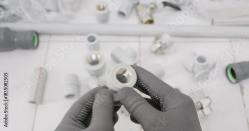 Technician points inside plastic adapter showing clean bore. Plumber gloved hand highlights thread pitch and confirms O ring groove seating face in correct position