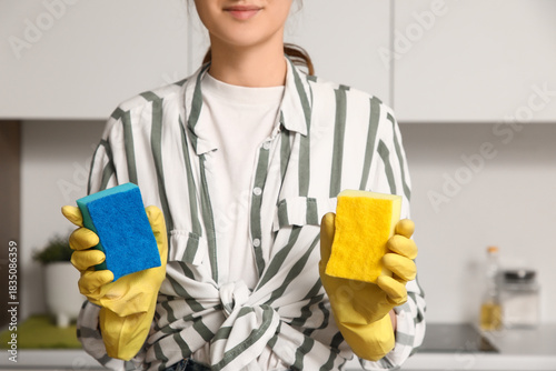 Woman with cleaning sponges...