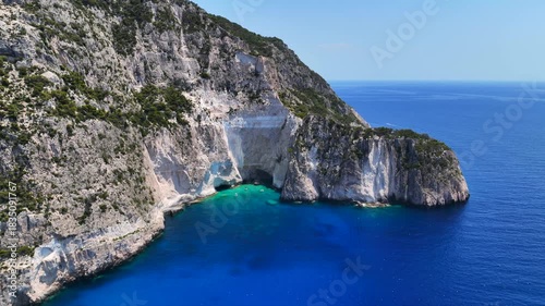 Aerial drone cinematic video of paradise sea caves of Keri with white cliffs and spectacular landscape creating a blue lagoon a true tourist attraction for yachts and boats, Zakinthos, Ionian, Greece
