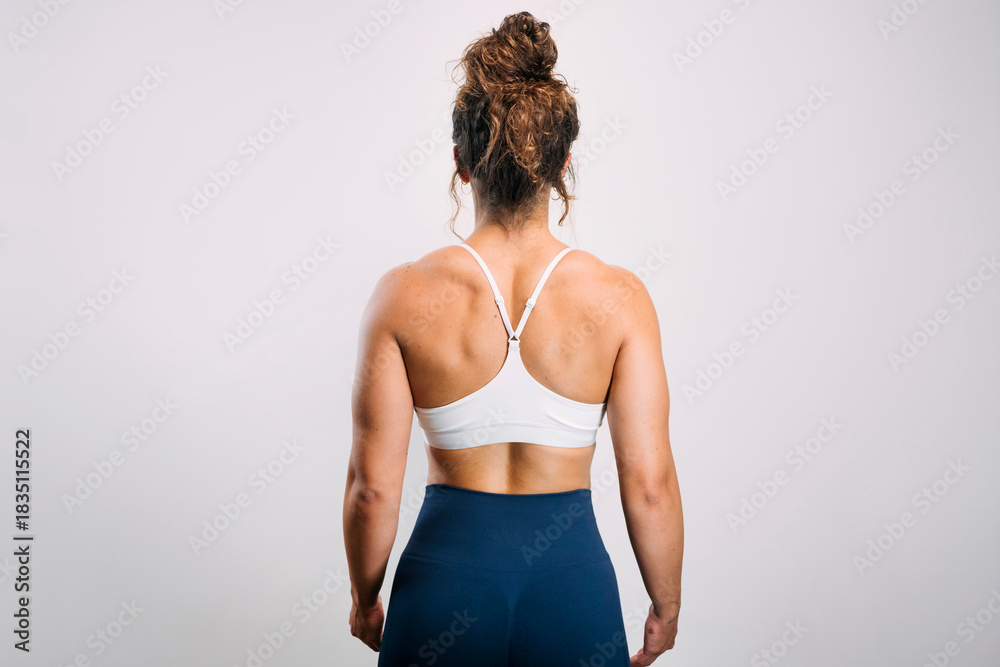 Fototapeta premium Woman showing strong muscular back in sportswear