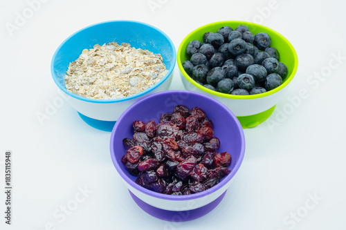 Bowls of mixed breakfast foods including Muesli Cranberries and Dried Cranberries.