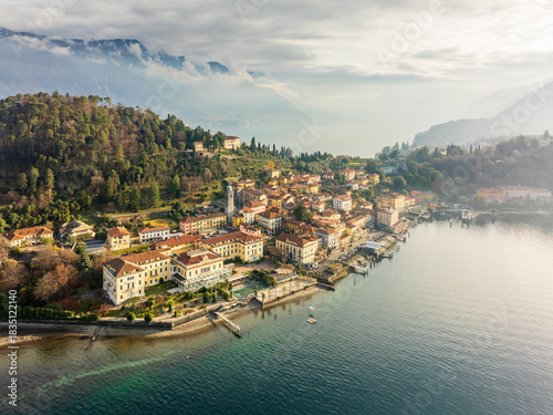 Aerial view of the picturesque town nestled along the serene lake, framed by majestic mountains under a soft, diffused light, Bellagio, Lombardia, Italy.