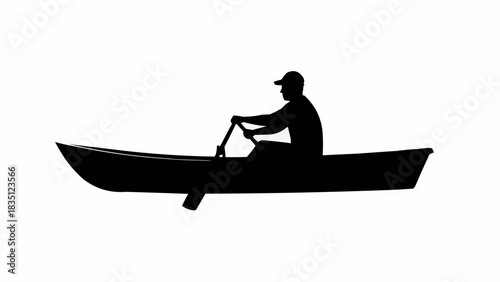 Silhouette of a person rowing a boat on the water.
