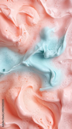 Abstract pastel swirls of pink and blue mix in soft foam texture