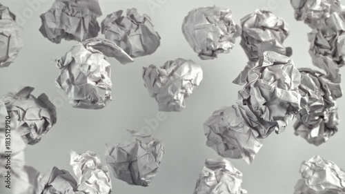 Crumpled paper flies up and falls on a white background. Filmed on a high-speed camera at 1000 fps. High quality FullHD footage
