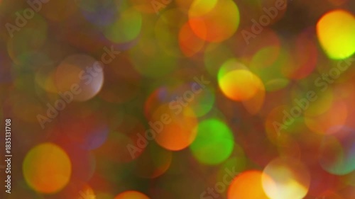 Multicolor Christmas Bokeh Seamless Loop. Festive abstract background of colorful glowing lights gently drifting and sparkling.