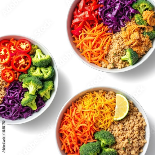 Overhead view of three bowls filled with colorful vegetables and grains on a white background surface