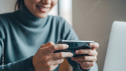 Smiling woman playing mobile game on smartphone indoors at home