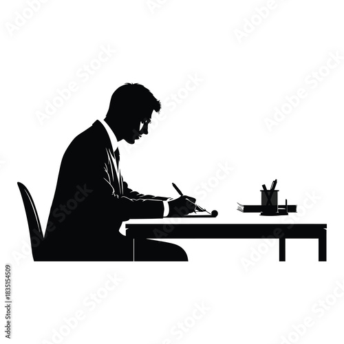 Concentrated businessman diligently working at his office desk with paperwork