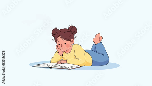 A young girl is lying on her stomach reading a book.