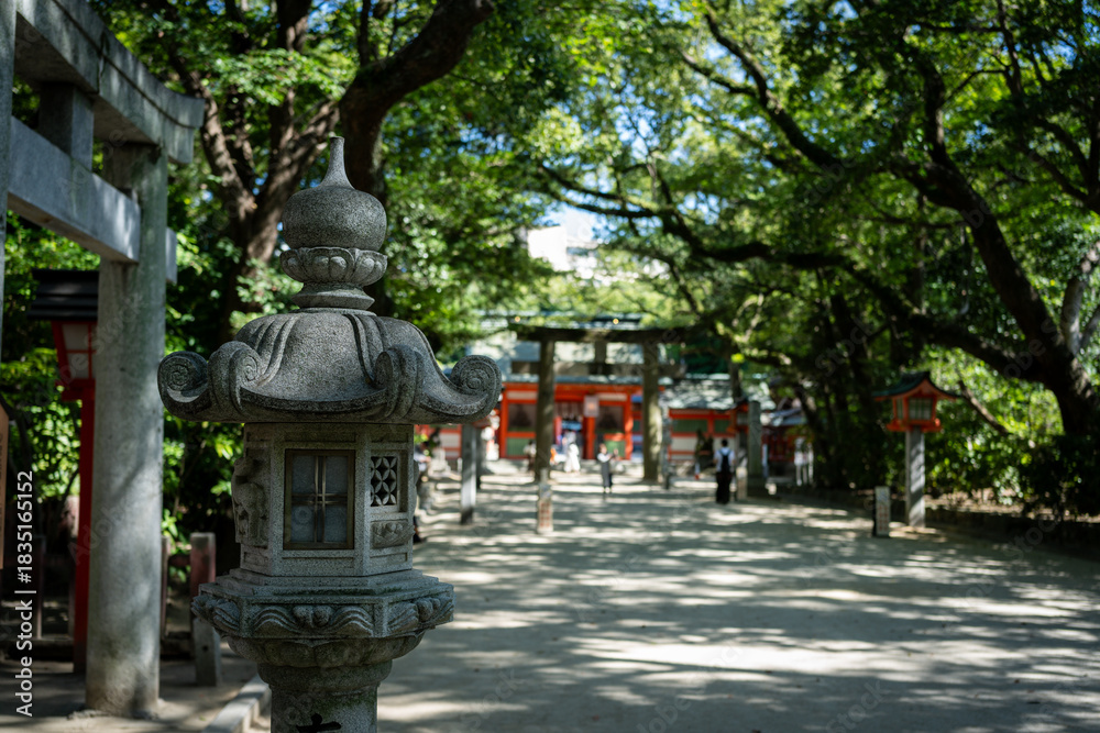 Obraz premium Japanese shrine with stone lantern and traditional architecture
