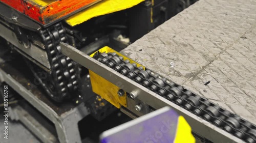 An automated conveyor chain transports refrigerator components through a modern factory assembly line.