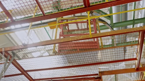 Overhead conveyor system delivers components through a modern refrigerator assembly factory.