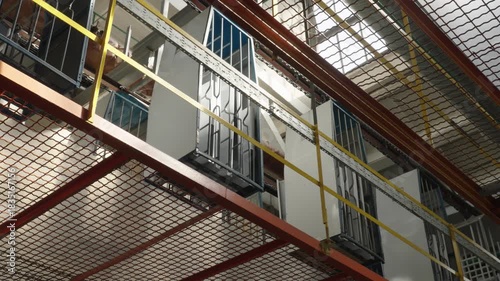 Overhead conveyor system delivers components through a modern refrigerator assembly factory.