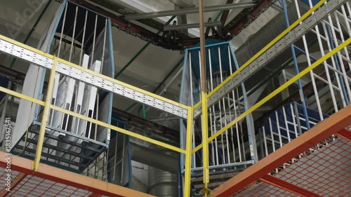 Overhead conveyor system delivers components through a modern refrigerator assembly factory.