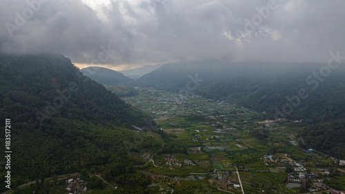 A small town among mountains and farmland in a mountain valley. Sumatra, Indonesia.