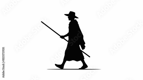 Silhouette of a man walking with a stick, symbolizing journey and determination.