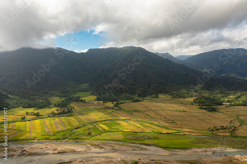 Aerial drone of Agricultural land and mountains with green forest. Philippines.