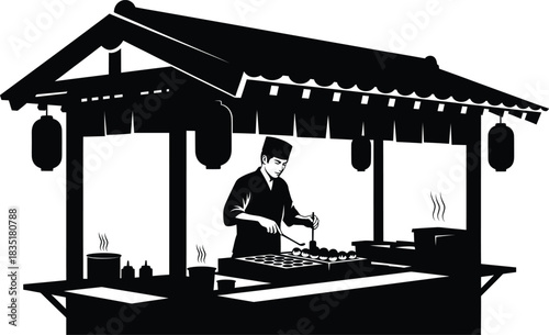Silhouette of street food vendor cooking at a traditional Japanese food stall