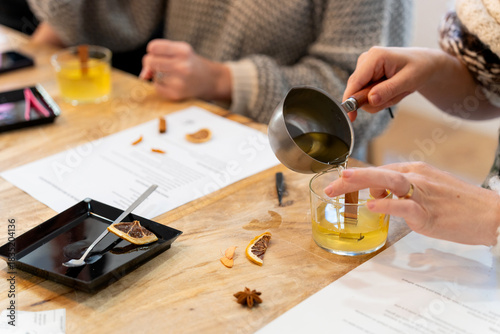 Woman pouring natural soy wax creating aromatic candle