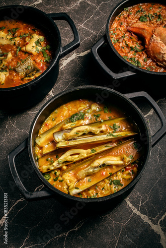 Portuguese traditional food fish soup  and seafood risotto meal on restaurant table in lisbon
