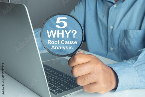 Hand holding magnifying glass focusing on 5 Whys Root Cause Analysis text, representing problem solving, business strategy, quality control, troubleshooting, and logic concept on laptop screen.