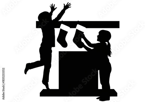 Silhouette of two children excitedly hanging Christmas stockings on a fireplace mantel.