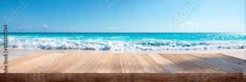 Empty wooden table overlooking serene tropical ocean beach with blue sky